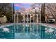 Refreshing pool with a patio and a mid-century modern building in the background at 6502 N Central Ave # B104, Phoenix, AZ 85012