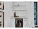 Modern wet bar with glass shelving and a mini-fridge at 6502 N Central Ave # B104, Phoenix, AZ 85012
