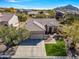 Single story home with a two-car garage and landscaped yard at 7259 E Tyndall St, Mesa, AZ 85207