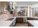 Kitchen features stainless steel appliances and brick accent wall at 10102 E Saddle Horn Trl, Scottsdale, AZ 85255