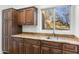 Well-equipped kitchenette featuring granite countertops and dark wood cabinets at 10102 E Saddle Horn Trl, Scottsdale, AZ 85255