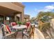 Covered patio with seating for four and views of pool at 10102 E Saddle Horn Trl, Scottsdale, AZ 85255