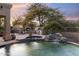 Inviting pool and spa area with outdoor kitchen and fireplace at 10102 E Saddle Horn Trl, Scottsdale, AZ 85255