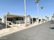 Street view of multiple manufactured homes, including a white single wide at 1027 S Prospector Dr, Apache Junction, AZ 85119