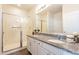 Elegant bathroom with granite countertops and a walk-in shower at 105 S 224Th Ave, Buckeye, AZ 85326