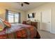 Comfortable bedroom with a king-size bed and mounted TV at 105 S 224Th Ave, Buckeye, AZ 85326