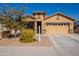 Single-story home with two-car garage and landscaped front yard at 105 S 224Th Ave, Buckeye, AZ 85326