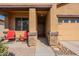 Covered entryway with stone accents and red chairs at 105 S 224Th Ave, Buckeye, AZ 85326