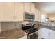 Modern kitchen with granite countertops and stainless steel appliances at 105 S 224Th Ave, Buckeye, AZ 85326