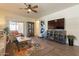 Relaxing living room featuring wood floors and a ceiling fan at 105 S 224Th Ave, Buckeye, AZ 85326