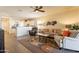 Bright and airy living room with wood floors and ceiling fan at 105 S 224Th Ave, Buckeye, AZ 85326