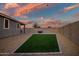 Artificial turf backyard with patio and string lights at 10806 W King St, Avondale, AZ 85323