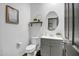 Simple bathroom with toilet, vanity, and floating shelf at 10806 W King St, Avondale, AZ 85323