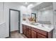 Bright bathroom features a double vanity and dark wood cabinets at 10806 W King St, Avondale, AZ 85323