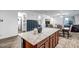 Kitchen island with granite countertop, offering additional seating and workspace at 10806 W King St, Avondale, AZ 85323