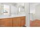 Well-lit bathroom with wood vanity and large mirror at 1179 N Granada Dr, Chandler, AZ 85226