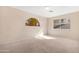 Cozy bedroom with plush carpet, neutral walls, and a unique half-moon window at 1179 N Granada Dr, Chandler, AZ 85226