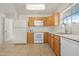 Kitchen featuring tile flooring, ample cabinets, and white appliances at 1179 N Granada Dr, Chandler, AZ 85226