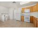 Bright kitchen with tile flooring, wooden cabinets, and white appliances at 1179 N Granada Dr, Chandler, AZ 85226