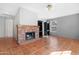 Inviting living room featuring tile floors, a brick fireplace, and built-in shelving at 1179 N Granada Dr, Chandler, AZ 85226