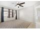 Bright and airy main bedroom with plush carpeting and ample natural light from a large window at 1179 N Granada Dr, Chandler, AZ 85226