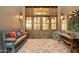 Rustic entryway with ornate wooden doors and herringbone flooring at 11890 N 118Th St, Scottsdale, AZ 85259