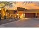 Beautiful desert home with warm lighting at dusk at 11890 N 118Th St, Scottsdale, AZ 85259