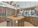 Gourmet kitchen with island, stainless steel appliances, and wood cabinetry at 11890 N 118Th St, Scottsdale, AZ 85259