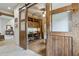 Home office with built-in wooden cabinets and barn doors at 11890 N 118Th St, Scottsdale, AZ 85259