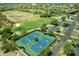 Aerial view of four well-maintained tennis courts at 11890 N 118Th St, Scottsdale, AZ 85259