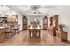 Bright dining room with hardwood floors and a large wooden table at 12450 W Fieldstone Dr, Sun City West, AZ 85375