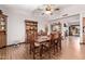 Classic dining room with hardwood floors and a wooden table with six chairs at 12450 W Fieldstone Dr, Sun City West, AZ 85375