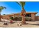 Ranch style home with attractive landscaping and palm trees at 12450 W Fieldstone Dr, Sun City West, AZ 85375