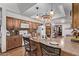 Modern kitchen with wood cabinets, granite countertops, and a breakfast bar at 12450 W Fieldstone Dr, Sun City West, AZ 85375