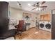 Laundry room with washer, dryer, and workspace at 12450 W Fieldstone Dr, Sun City West, AZ 85375