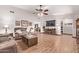 Bright living room with hardwood floors and a large TV at 12450 W Fieldstone Dr, Sun City West, AZ 85375