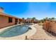 Large kidney shaped pool with spacious patio and landscaping at 12450 W Fieldstone Dr, Sun City West, AZ 85375