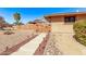 Pathway to backyard with wood gate and landscape lighting at 12450 W Fieldstone Dr, Sun City West, AZ 85375