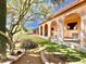 Southwest style home with covered patio, mature trees, and desert landscaping at 13602 S Garnet Rd, Buckeye, AZ 85326