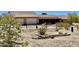 Ranch style home with two car garage and desert landscaping at 13602 S Garnet Rd, Buckeye, AZ 85326