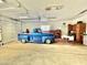 Extra-large garage with a classic car and workbenches at 13602 S Garnet Rd, Buckeye, AZ 85326