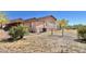 View of the home's exterior, showcasing its design and landscaping at 13602 S Garnet Rd, Buckeye, AZ 85326