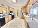 Kitchen with double sink, ample cabinetry, and tile flooring at 13602 S Garnet Rd, Buckeye, AZ 85326