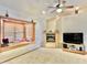 Living room with corner window seat and fireplace at 13602 S Garnet Rd, Buckeye, AZ 85326