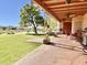 Covered patio with ceiling fans, seating, and a built-in grill at 13602 S Garnet Rd, Buckeye, AZ 85326