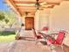 Relaxing covered patio with red seating and ceiling fans at 13602 S Garnet Rd, Buckeye, AZ 85326