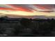 Stunning sunset view over desert landscape and mountains at 13602 S Garnet Rd, Buckeye, AZ 85326