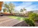 Landscaped backyard featuring artificial turf and a brick patio at 13608 N 150Th Ln, Surprise, AZ 85379