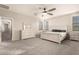 Bright bedroom featuring a plush carpet and ceiling fan at 13608 N 150Th Ln, Surprise, AZ 85379