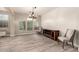 Bright dining room featuring hardwood floors and a rustic media console at 13608 N 150Th Ln, Surprise, AZ 85379